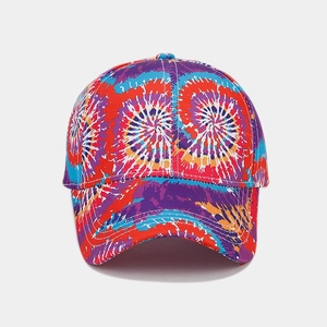 Close-up of rainbow tie-dye baseball cap showing detailed spiral pattern and canvas texture