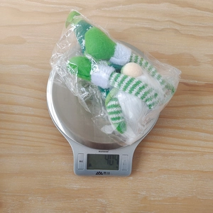 Close-up of a Christmas gnome doll on a digital scale showing 40.4g lightweight detail