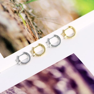 Close-up of S925 silver and gold marquise zircon hoop earrings on a clean background
