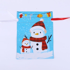 Blue Christmas drawstring gift bag with snowman print and ribbon for party favors