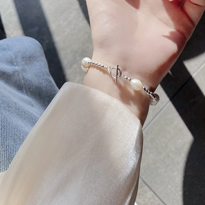 Detailed view of baroque freshwater pearl bracelet with silver beads and OT toggle clasp