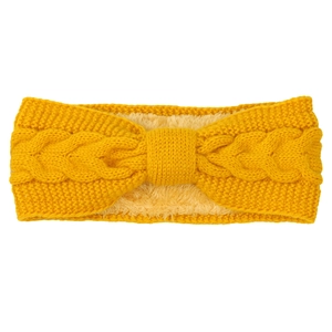 Detail of cable knit pattern and yellow fleece lining on winter bow headband