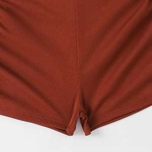Macro shot of rust orange ribbed knit bikini bottom with detailed vertical texture and seams