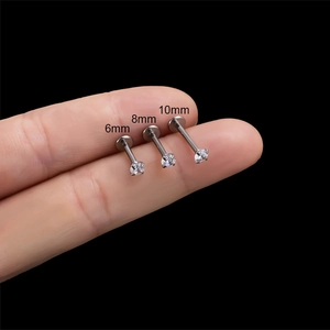 G23 titanium labret studs with zircon in 6mm, 8mm, and 10mm lengths shown on finger