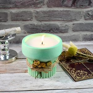 Mint green ceramic candle cup with textured base, vintage rope, and dried rose detail