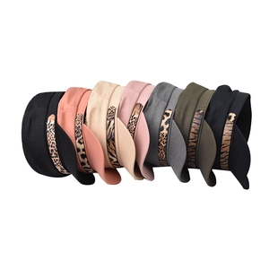 Flat lay of multi-color newsboy hats with stylish leopard print decorative chain bands