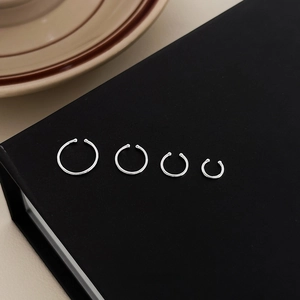 Minimalist S999 sterling silver hoop earrings set in four various sizes on black background