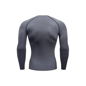 Detail view of breathable grey compression shirt with contrast stitching on high-stretch fabric