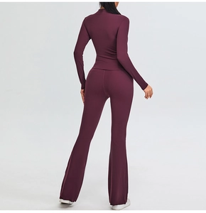 Slim fit deep plum yoga set featuring a half-zip long sleeve top and flared yoga pants