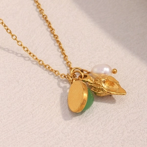18K gold plated stainless steel necklace with green gem, pearl, and leaf pendant charms
