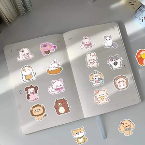 Cute cartoon animal stickers applied on a notebook page for laptop and luggage decor