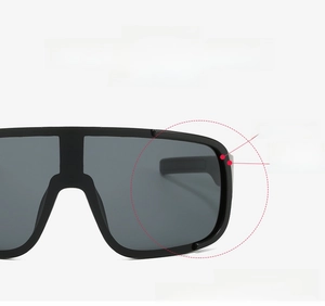 Close-up of oversized black flat top cycling sunglasses showing aerodynamic windproof frame