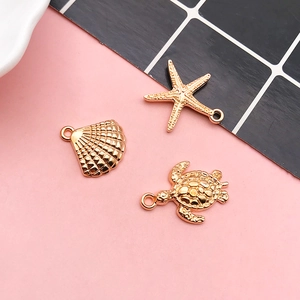 Detailed view of gold marine alloy pendants featuring starfish, shell, and sea turtle shapes