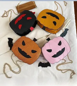 Detail of four colorful pumpkin cross-body bags with glitter wings for Halloween
