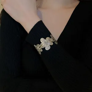 Vintage gold flower open cuff bracelet with brushed metallic texture and floral design
