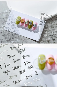 Detail of 3D gradient cursive letter nail stickers in black, white, and silver finishes