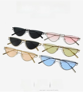 Flat lay of cat-eye metal sunglasses in six vibrant colors with double bridge design