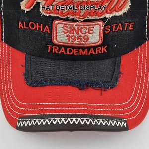 Macro detail of vintage baseball cap with 3D embroidery and distressed denim edges