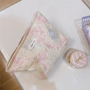 Detailed view of floral jacquard texture and Simple Wish label on bubble fabric makeup bag