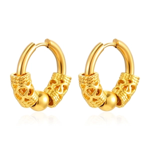 Macro detail of gold-plated stainless steel hoop earrings with dragon pattern cylinders