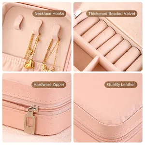 Pink faux leather travel jewelry box with necklace hooks and velvet ring storage slots