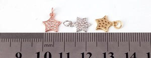 Macro view of 10mm star pendants in gold, silver, and rose gold with scale measurement