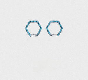 Macro detail of S925 sterling silver hexagonal stud earrings with turquoise pavé stones