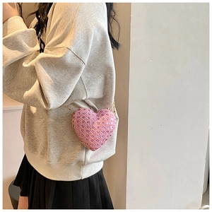 Pink heart-shaped evening clutch bag with sparkling rhinestones and golden chain strap
