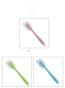 Selection of colorful silicone spatulas in pink green and blue for baking