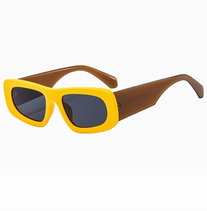 Detailed side view of yellow square sunglasses with transparent brown temples