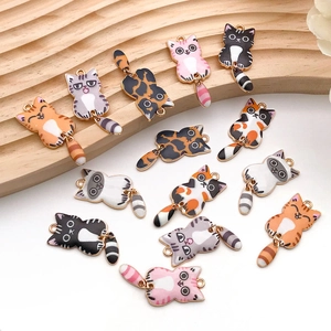 Detail of colorful enamel cat pendants with movable tails for DIY jewelry making