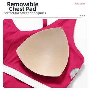 Detail view of the removable chest pads and mesh fabric on a fuchsia yoga sports bra