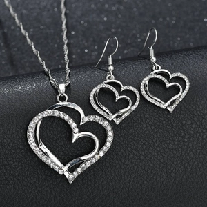 Elegant silver double heart jewelry set with sparkling crystals on black leather