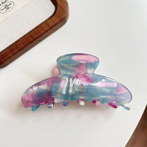 Elegant marble acetate hair claw clip in pink and blue for vintage French hairstyles.