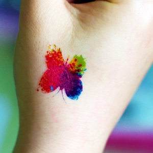 Macro shot of waterproof colorful butterfly temporary tattoo sticker on skin for parties
