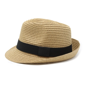 Detailed close-up of woven straw texture and black grosgrain ribbon on a summer fedora hat