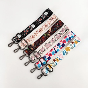 Adjustable crossbody shoulder straps with various colorful floral and paisley prints