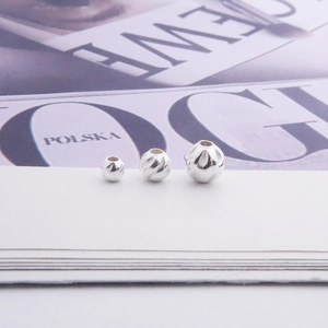 Macro shot of three S925 sterling silver textured water ripple beads for DIY jewelry