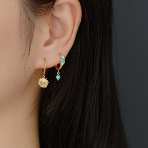 Bohemian S925 silver evil eye hoop earrings with turquoise accents on model