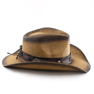 Detail of woven straw cowboy hat featuring brown gradient texture and vintage leather band