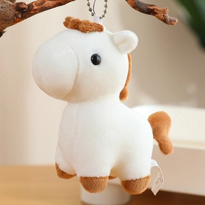 Cute white plush pony keychain with brown mane hanging on a branch for bag decoration
