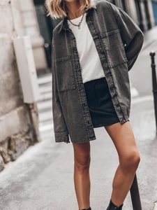 Detailed view of grey washed cotton denim oversized shirt with large pockets and buttons