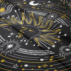 Close-up detail of celestial sun and moon patterns on black woven tapestry fabric