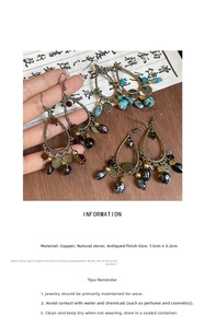 Detail of vintage teardrop earrings with bronze base and natural stone insets