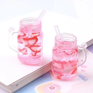 Macro view of miniature pink strawberry cold drink models with ice and straw details