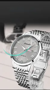 Detail of Comudir automatic watch with silver stainless steel band and day-date display
