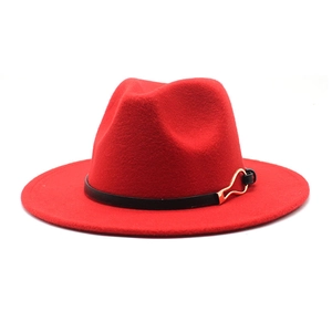 Detail of red wool fedora hat with black leather band and golden buckle detail