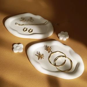 Minimalist plaster jewelry display tray in creamy white for rings and necklaces