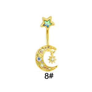 Macro detail of gold plated star and moon navel ring set with sparkling colorful zircons