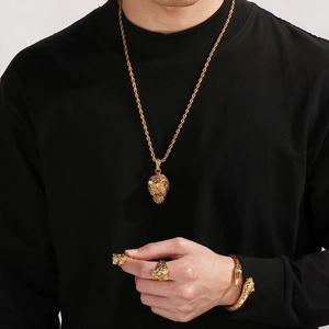 Close-up of golden tiger head jewelry set including necklace, ring, and bracelet on a model